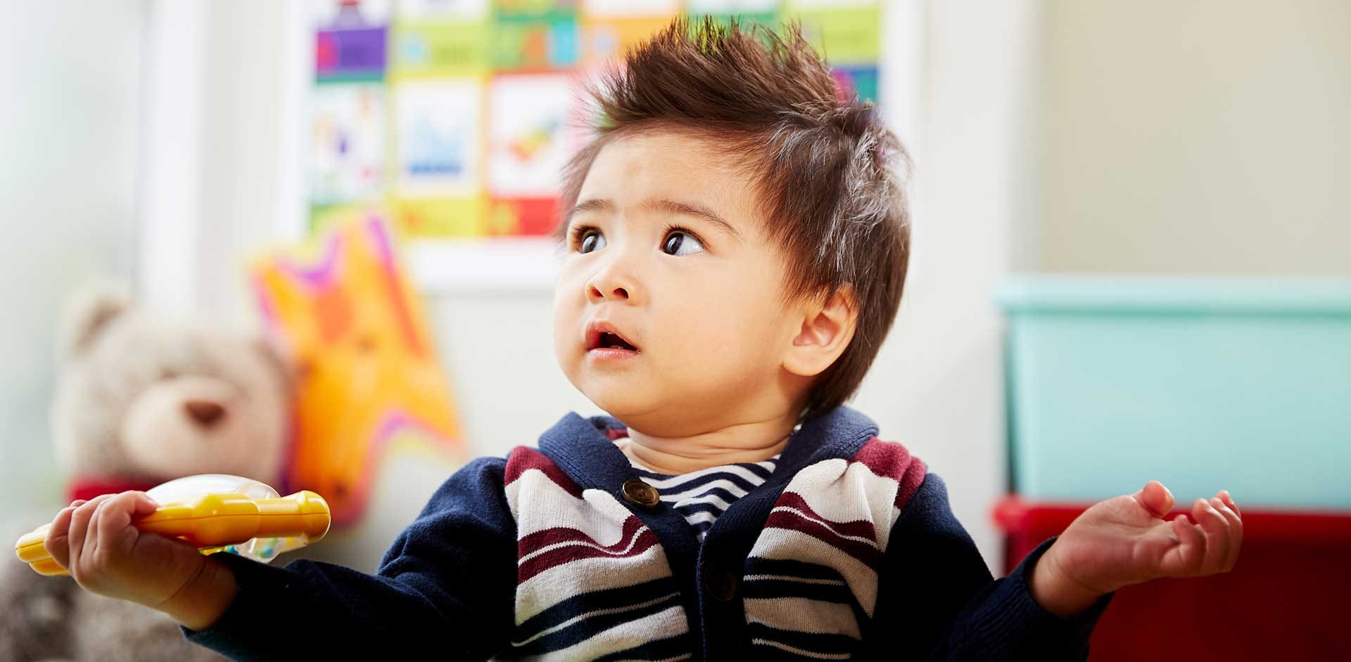 An infant playing with a sensory toy